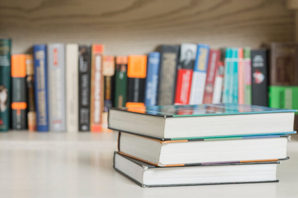 three-books-near-bookshelf